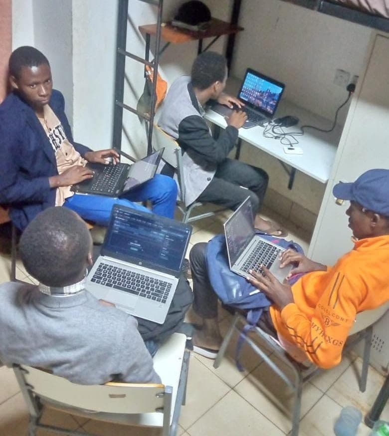 Collably's first training cohort working on laptops